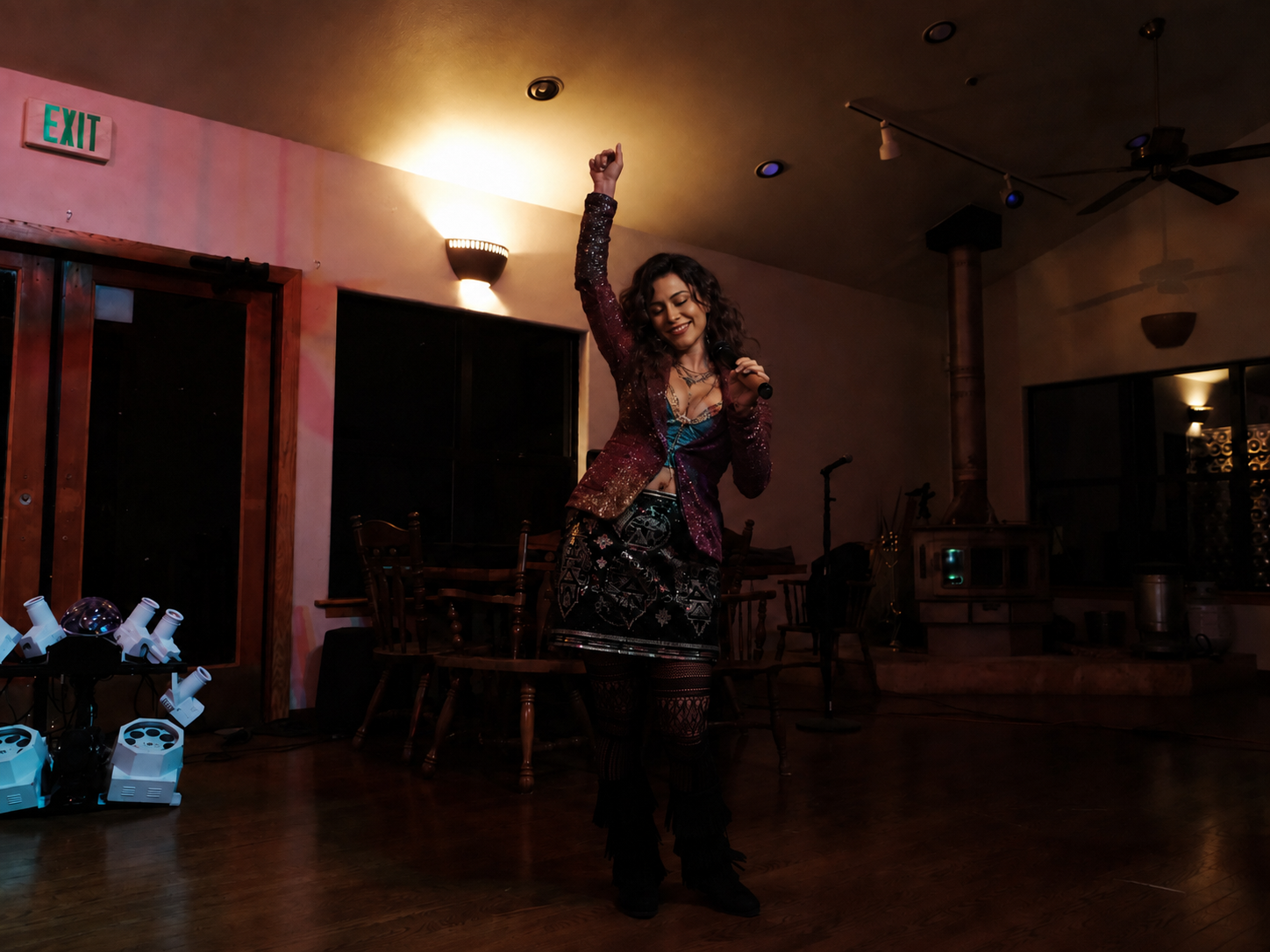 Private event guest singing under warm lounge lighting