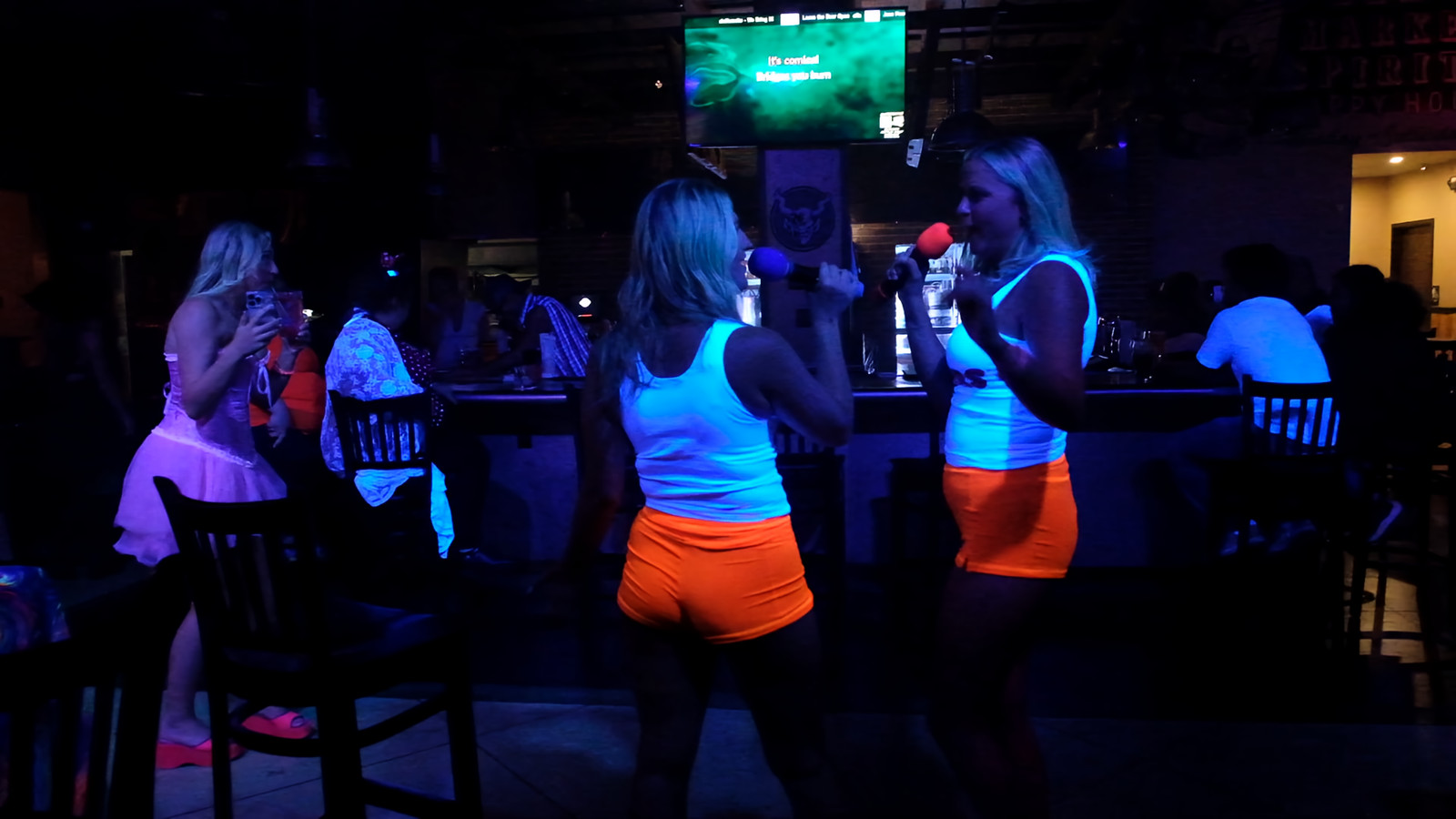 Guests glowing under ultraviolet party lighting