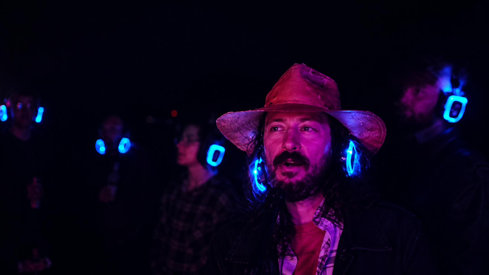 Guests enjoying a Silent Karaoke event with illuminated wireless headphones