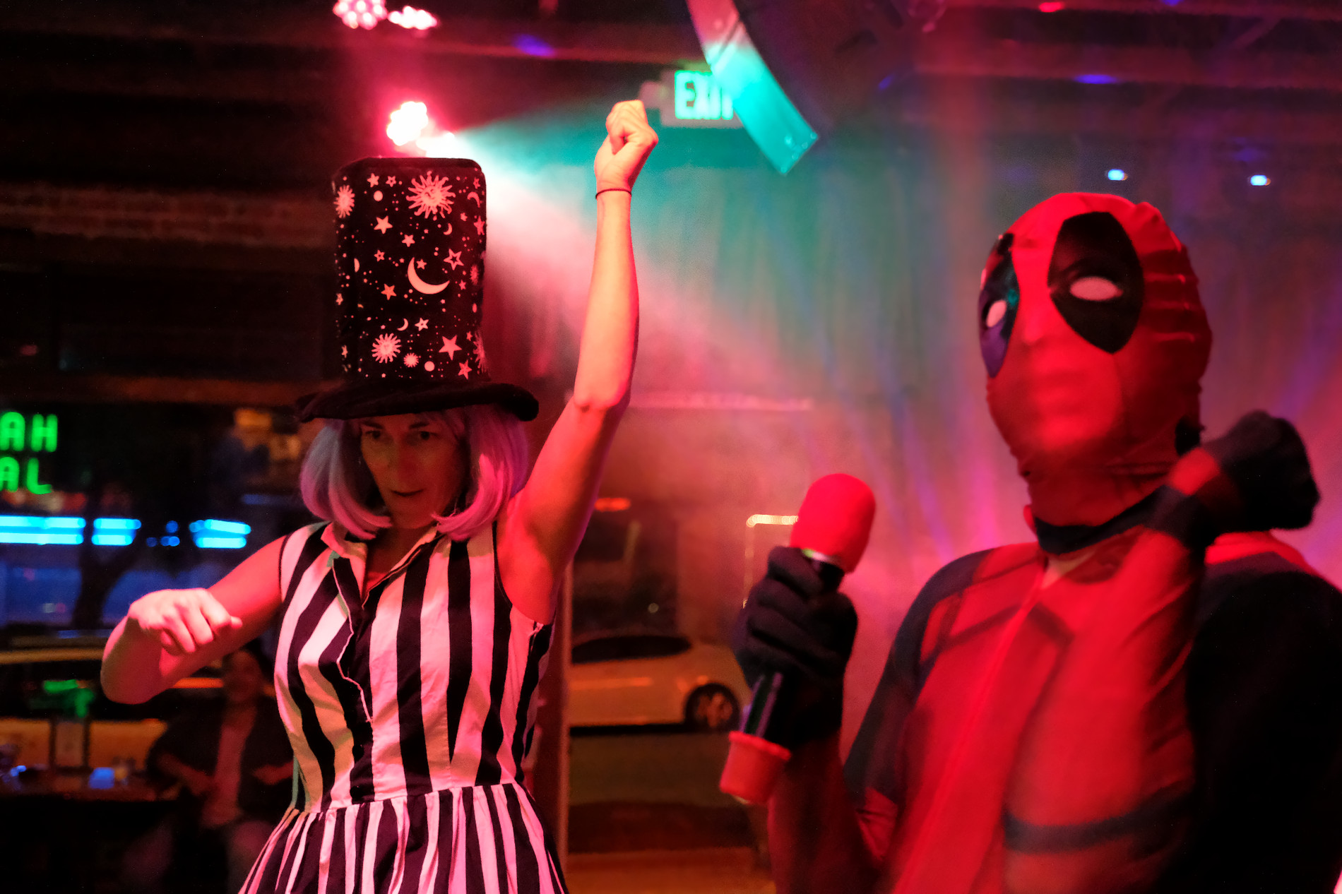 Costumed singers performing at a themed karaoke event